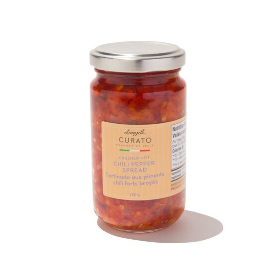 Longo’s Curato crushed hot chili pepper spread in a glass jar, authentic Italian condiment.